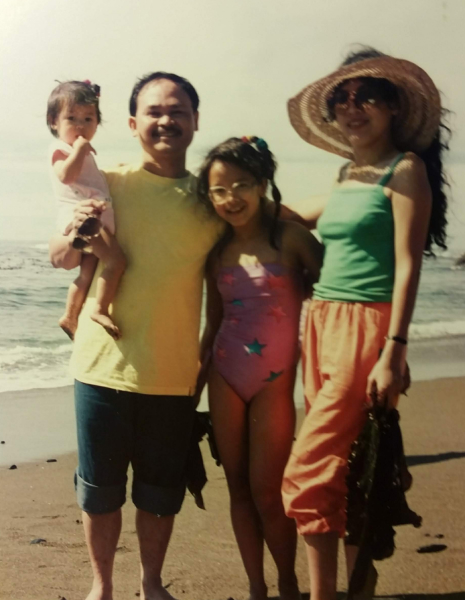 Emily Dang as a baby with her Mother, Father and Sister on the beach in the 1980's