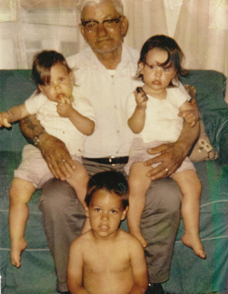 Michelle Cardinal sitting on her Grandfather’s lap with her Brother and Sister